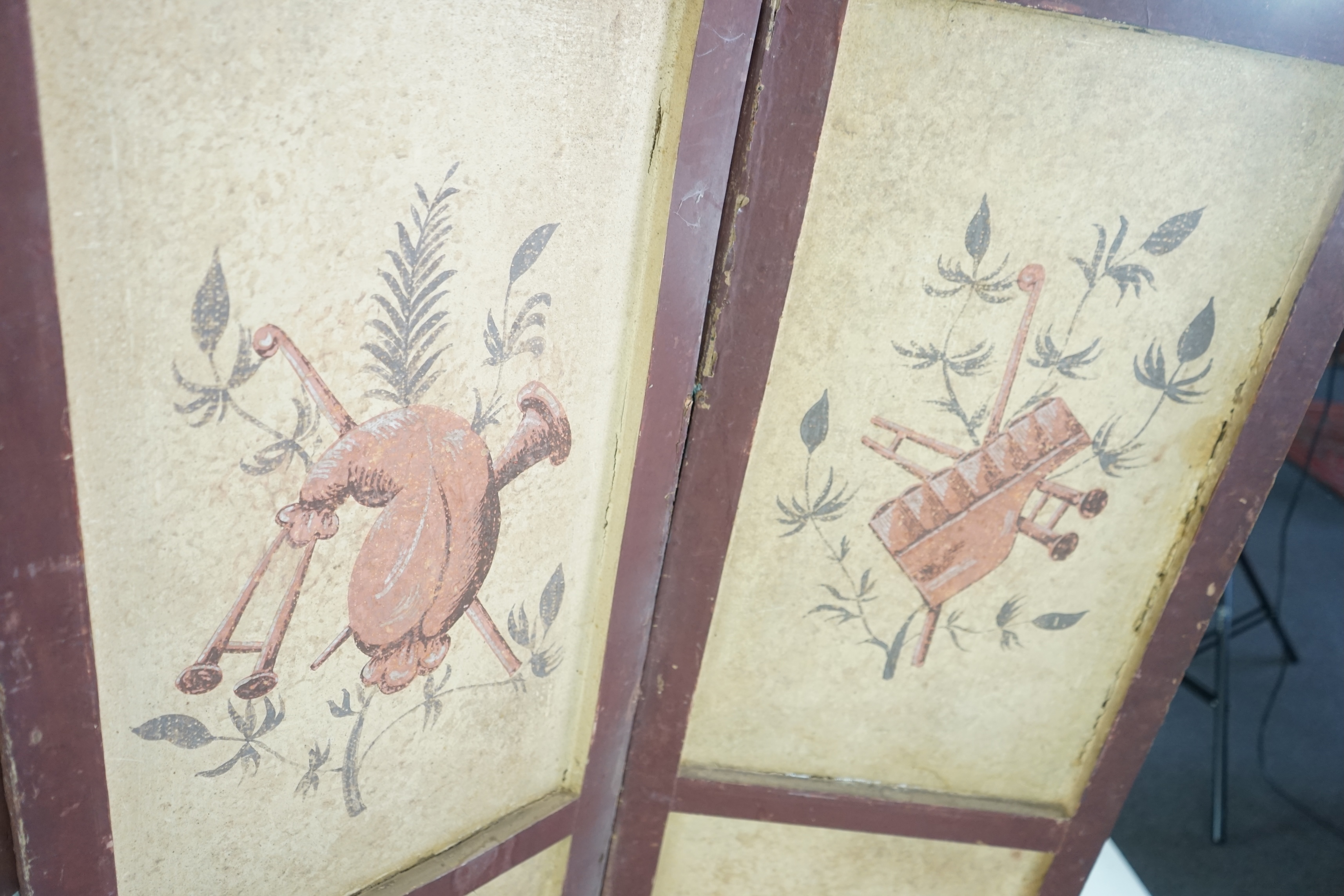 A French Empire four-leaf painted screen, gouache on paper, attributed to Dufour & Leroy, decorated with figures in the grounds of a chateau, the reverse with musical trophies, 47cm wide, 150cm high. Condition - a variet